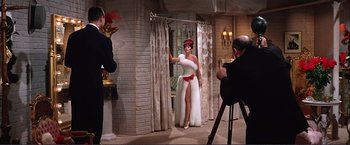 Movie still from “Gypsy” (1962), directed by Mervyn LeRoy – A woman in a white dress and a man in a black suit; Wide shot, Low angle