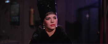 Movie still from “Gypsy” (1962), directed by Mervyn LeRoy – A woman in a black dress and a black hat; Close Up shot, Low angle