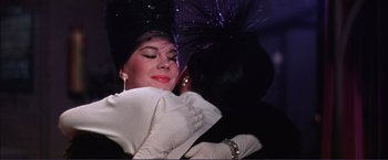 Movie still from “Gypsy” (1962), directed by Mervyn LeRoy – A person wearing a hat and a dress; Close Up shot, Low angle