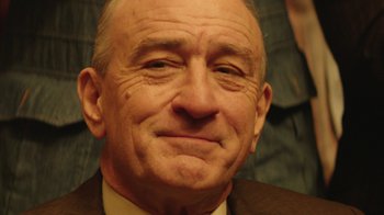 Movie still from “Hands of Stone” (2016), directed by Jonathan Jakubowicz – An older man wearing a suit and tie; Close Up shot, Low angle