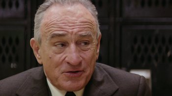 Movie still from “Hands of Stone” (2016), directed by Jonathan Jakubowicz – An older man wearing a suit and tie; Close Up shot, Over the shoulder angle