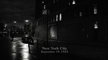 Movie still from “Hands of Stone” (2016), directed by Jonathan Jakubowicz – A black - and - white photo of a city street at night; Extreme Wide shot, High angle