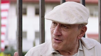 Movie still from “Hands of Stone” (2016), directed by Jonathan Jakubowicz – An older man wearing a white hat looking to his left; Close Up shot, Low angle