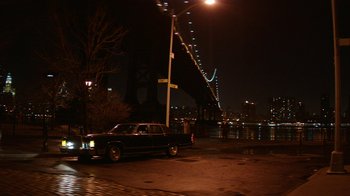 Movie still from “Hands of Stone” (2016), directed by Jonathan Jakubowicz – A car parked on the side of the road at night; Extreme Wide shot, High angle