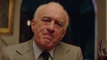 Movie still from “Hands of Stone” (2016), directed by Jonathan Jakubowicz – An older man wearing a suit and tie; Close Up shot, Low angle