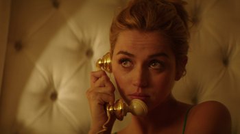 Movie still from “Hands of Stone” (2016), directed by Jonathan Jakubowicz – A woman holding a phone to her ear; Close Up shot, High angle