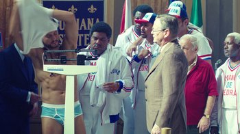 Movie still from “Hands of Stone” (2016), directed by Jonathan Jakubowicz – A group of men standing next to each other; Medium shot, Over the shoulder angle
