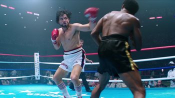 Movie still from “Hands of Stone” (2016), directed by Jonathan Jakubowicz – Two boxers in a boxing ring during a match; Wide shot, Low angle
