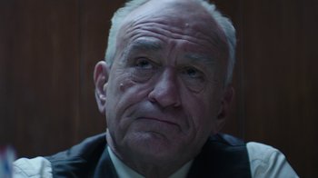 Movie still from “Hands of Stone” (2016), directed by Jonathan Jakubowicz – An old man with a frowning look on his face; Close Up shot, Low angle