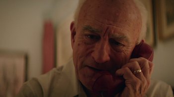Movie still from “Hands of Stone” (2016), directed by Jonathan Jakubowicz – An older man talking on a cell phone; Close Up shot, Low angle