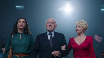 Movie still from “Hands of Stone” (2016), directed by Jonathan Jakubowicz – A man and two women standing next to each other in front of a wall; Medium shot, Low angle