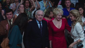 Movie still from “Hands of Stone” (2016), directed by Jonathan Jakubowicz – An older man and a woman in a red dress; Medium shot, High angle
