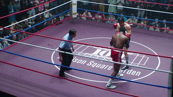 Movie still from “Hands of Stone” (2016), directed by Jonathan Jakubowicz – Two men in a boxing ring during a match; Wide shot, High angle