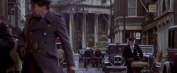 Movie still from “Hanover Street” (1979), directed by Peter Hyams – A group of men riding bikes down a street; Wide shot, Over the shoulder angle