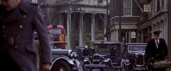 Movie still from “Hanover Street” (1979), directed by Peter Hyams – An old fashioned car driving down a street; Extreme Wide shot, High angle