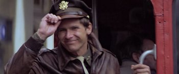 Movie still from “Hanover Street” (1979), directed by Peter Hyams – A man wearing a hat and a leather jacket; Close Up shot, Low angle