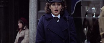 Movie still from “Hanover Street” (1979), directed by Peter Hyams – A woman wearing a hat and a coat; Close Up shot, Over the shoulder angle