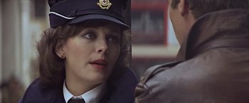 Movie still from “Hanover Street” (1979), directed by Peter Hyams – A woman in a police uniform looking at a man in a leather jacket; Close Up shot, Over the shoulder angle