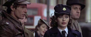 Movie still from “Hanover Street” (1979), directed by Peter Hyams – A group of people standing next to each other on the street; Close Up shot, Low angle