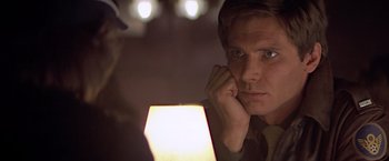 Movie still from “Hanover Street” (1979), directed by Peter Hyams – A person looking at a light; Close Up shot, Over the shoulder angle