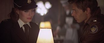 Movie still from “Hanover Street” (1979), directed by Peter Hyams – A woman and a man standing next to each other; Close Up shot, Over the shoulder angle