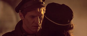 Movie still from “Hanover Street” (1979), directed by Peter Hyams – A person wearing a hat; Close Up shot, Over the shoulder angle