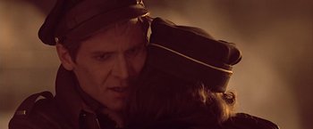 Movie still from “Hanover Street” (1979), directed by Peter Hyams – A person wearing a hat; Close Up shot, Over the shoulder angle