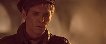 Movie still from “Hanover Street” (1979), directed by Peter Hyams – A person wearing a hat; Close Up shot, Over the shoulder angle