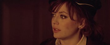 Movie still from “Hanover Street” (1979), directed by Peter Hyams – A person wearing a hat and looking to the side; Close Up shot, Over the shoulder angle