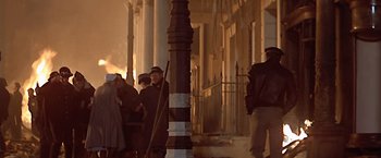 Movie still from “Hanover Street” (1979), directed by Peter Hyams – A group of people standing next to each other near a pole; Wide shot, Low angle
