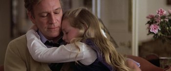 Movie still from “Hanover Street” (1979), directed by Peter Hyams – A man and a little girl hugging each other; Close Up shot, Over the shoulder angle