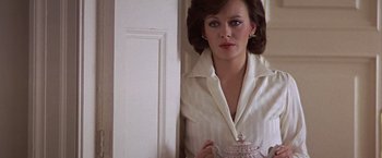 Movie still from “Hanover Street” (1979), directed by Peter Hyams – A woman standing in a doorway holding a tea pot; Close Up shot, Low angle