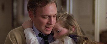 Movie still from “Hanover Street” (1979), directed by Peter Hyams – A man holding a little girl in his arms; Close Up shot, Low angle