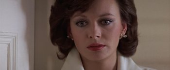 Movie still from “Hanover Street” (1979), directed by Peter Hyams – A woman's face in a white jacket; Close Up shot, Over the shoulder angle