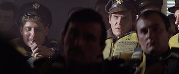 Movie still from “Hanover Street” (1979), directed by Peter Hyams – A person wearing a hat; Close Up shot, Over the shoulder angle