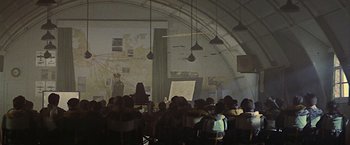 Movie still from “Hanover Street” (1979), directed by Peter Hyams – A group of people sitting in a room; Extreme Wide shot, High angle