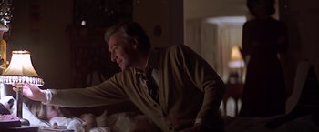 Movie still from “Hanover Street” (1979), directed by Peter Hyams – A man sitting in front of a window at night; Medium shot, Over the shoulder angle