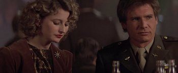 Movie still from “Hanover Street” (1979), directed by Peter Hyams – A man and a woman sitting at a table with a bottle; Close Up shot, Over the shoulder angle