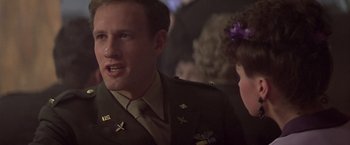 Movie still from “Hanover Street” (1979), directed by Peter Hyams – A man in a military uniform talking to a woman; Close Up shot, Over the shoulder angle