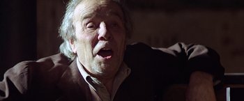 Movie still from “Hanover Street” (1979), directed by Peter Hyams – An old man with a beard and a white shirt; Close Up shot, Low angle