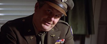Movie still from “Hanover Street” (1979), directed by Peter Hyams – A man in a military uniform with medals around his neck; Close Up shot, Low angle