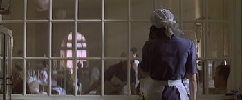 Movie still from “Hanover Street” (1979), directed by Peter Hyams – A person in a kitchen talking on a phone; Medium shot, Low angle