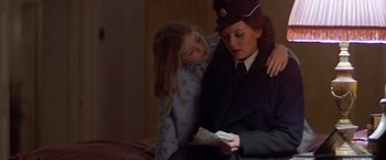 Movie still from “Hanover Street” (1979), directed by Peter Hyams – A woman and a girl are looking at something on a phone; Medium shot, Over the shoulder angle