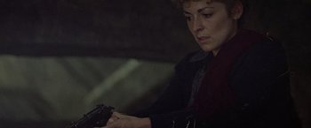 Movie still from “Hanover Street” (1979), directed by Peter Hyams – A woman is holding a gun in a dark room; Close Up shot, High angle