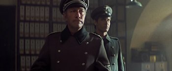 Movie still from “Hanover Street” (1979), directed by Peter Hyams – Two men in military uniforms standing next to each other; Medium shot, Low angle