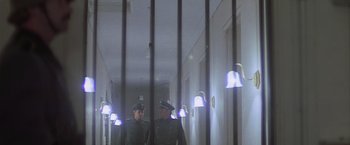 Movie still from “Hanover Street” (1979), directed by Peter Hyams – Two men in uniforms are standing in a hallway; Wide shot, Low angle