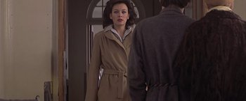 Movie still from “Hanover Street” (1979), directed by Peter Hyams – A woman in a trench coat looking in the mirror; Medium shot, Over the shoulder angle