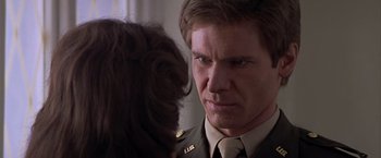 Movie still from “Hanover Street” (1979), directed by Peter Hyams – A person in a military uniform; Close Up shot, Over the shoulder angle