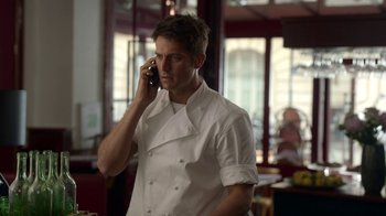 Movie still from “Emily in Paris” (2020), created by Darren Star – A man in a chef's outfit talking on a cell phone; Close Up shot, Low angle