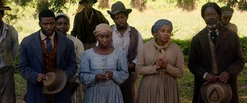 Movie still from “Harriet” (2019), directed by Kasi Lemmons – A group of people standing next to each other in a field; Medium shot, High angle